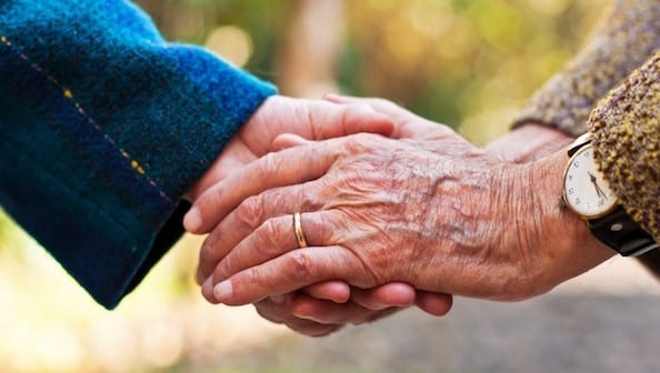 Old couple holding hands